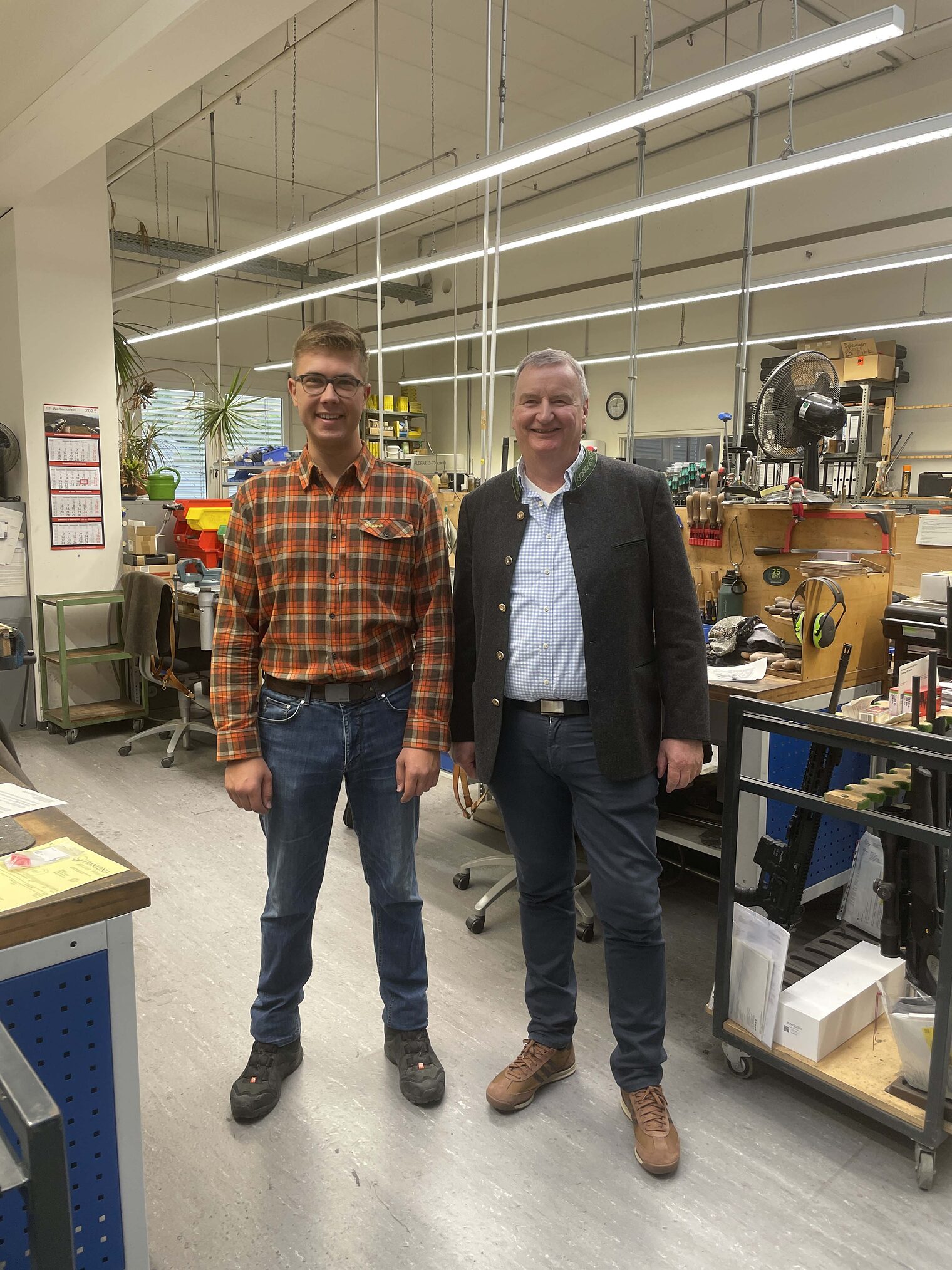 Büchsenmacher Zwei Männer stehen in der Werkstatt